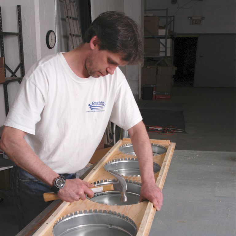 Shop Owner installing starter collars for filter bags